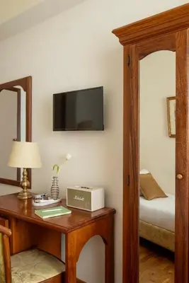 a dining room with tables and chairs and curtains at Hotel Cortina in Rome