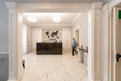 a man walking through a hallway in a building at Hotel Virgilio in Rome