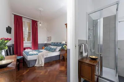 a bedroom with a bed and a glass shower at All'Orologio in Rome