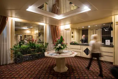 a person walking through a bathroom with a mirror at Atlante Garden Hotel in Rome