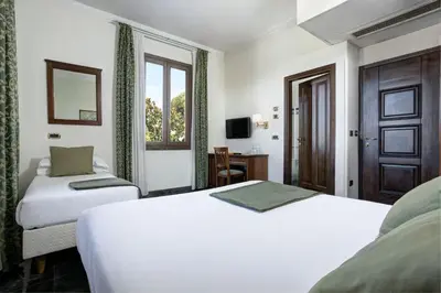 a hotel room with two beds and a window at Grand Hotel Gianicolo in Rome