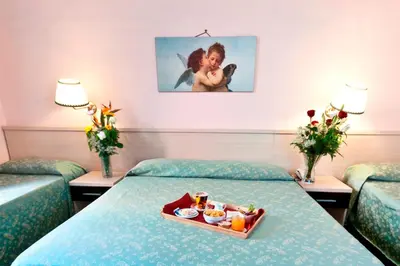a hotel room with a tray of food on a bed at Hotel Priscilla in Rome