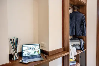 a laptop computer sitting on a desk in a closet at Rome Garden Hotel in Rome