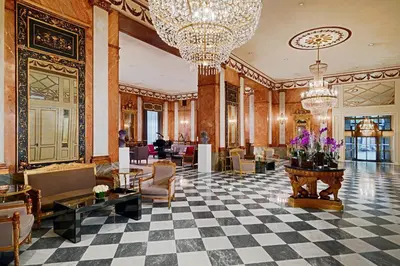 a lobby with a checkered floor and chandeliers at The Westin Excelsior, Rome in Rome