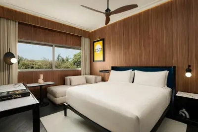 a bedroom with a large white bed and a couch at Cardo Roma, Autograph Collection in Rome