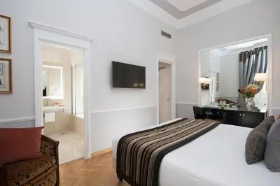 a hotel room with a bed and a bathroom at Bettoja Hotel Massimo d'Azeglio in Rome