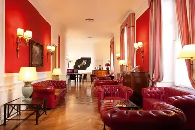 a living room filled with red furniture and red walls at Hotel Nord Nuova Roma in Rome