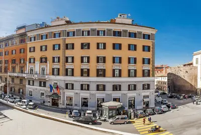 a large building with cars parked in front of it at Hotel Nord Nuova Roma in Rome