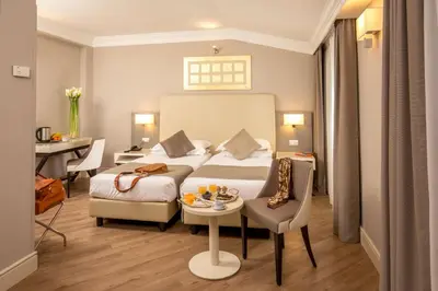 a hotel room with a bed and a table at Ludovisi Palace Hotel in Rome