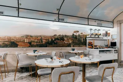 a restaurant with tables and chairs and a painting on the wall at Hotel Pantheon in Rome