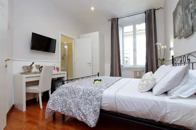 a bedroom with a bed and a desk with a computer at 4BNB - Otranto Vatican Apartment in Rome