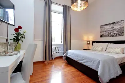 a bedroom with a bed and a desk and a window at 4BNB - Otranto Vatican Apartment in Rome