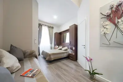 a hotel room with a bed and a living room at Sweet Holidays In Rome in Rome