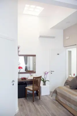 a bedroom with a bed and a desk and a chair at Sweet Holidays In Rome in Rome