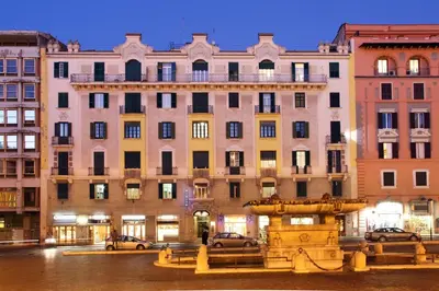 a large building with a fountain in front of it at Hotel Dorica in Rome
