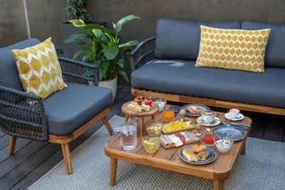 a tray of food on a coffee table with two chairs at Hotel Del Corso in Rome