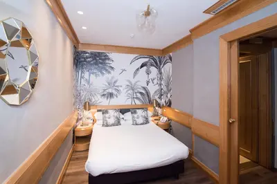 a small room with a bed and a mirror at Hotel White in Rome