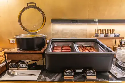a grill with sausages on a counter in a kitchen at Hotel Accademia in Rome