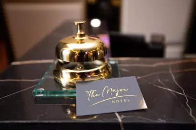 a table with a teapot and a sign on it at The Major Hotel in Rome