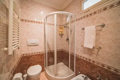 a bathroom with a shower and a toilet at GH Hotel San Giusto in Rome