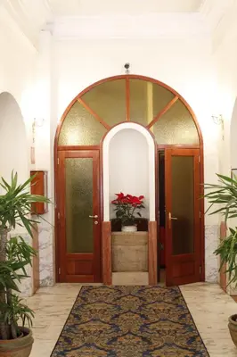an entrance to a room with two wooden doors at Hotel Pace Helvezia in Rome
