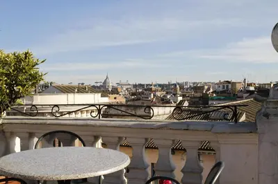 a table on a balcony with a view of a city at Hotel Genio in Rome