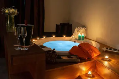 a bathroom with a tub with candles and lights at The Code Hotel in Rome