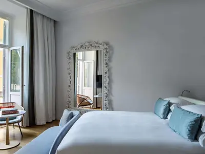 a bedroom with a bed and a bathroom with a tub at Sofitel Roma Villa Borghese in Rome