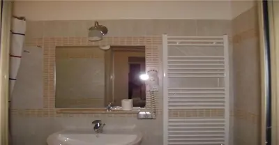 a bathroom with a sink and a mirror at Hotel Elide in Rome