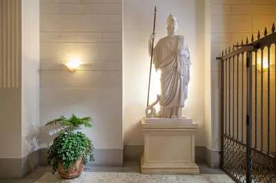 a statue of a man standing next to a staircase at Hotel Sant'Angelo in Rome