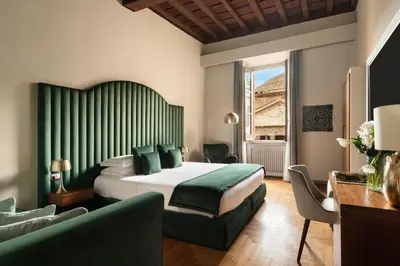 a hotel room with a bed and a couch at Antico Albergo del Sole al Pantheon in Rome