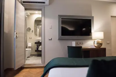 a bedroom with a bed and a television on the wall at Antico Albergo del Sole al Pantheon in Rome