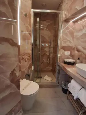 a bathroom with a sink and a toilet and a mirror at Hotel Fiori in Rome