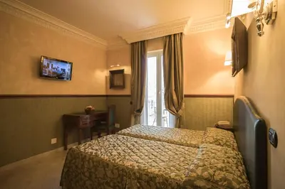 a hotel room with a bed and a window at Hotel Donatello in Rome