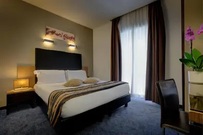 a hotel room with a bed and a desk at Hotel Rinascimento in Rome