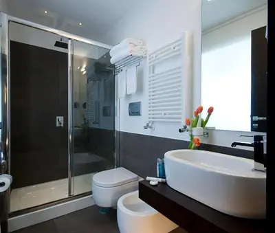 a bathroom with a tub and a toilet and a sink at Hotel Rinascimento in Rome