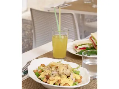 a table with a plate of food and a glass of orange juice at Golden Tulip Rome Piram in Rome