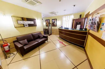 a waiting room with a leather couch in a hospital at Hotel Lirico in Rome