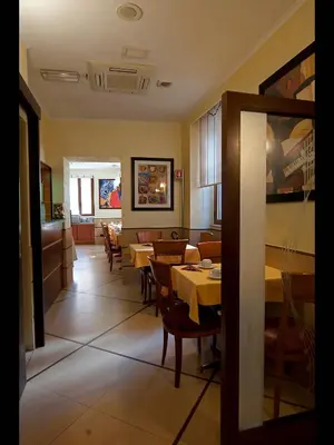 a dining room with tables and chairs in a restaurant at Hotel Lirico in Rome