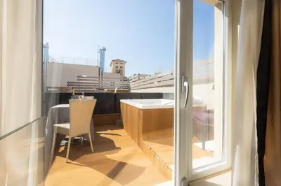 a balcony with a table and a glass door at Hotel Castellino Roma in Rome