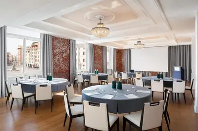 a conference room with tables and chairs and a projection screen at Sina Bernini Bristol, Autograph Collection in Rome