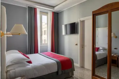 a hotel room with a bed and a mirror at Hotel Montecarlo in Rome