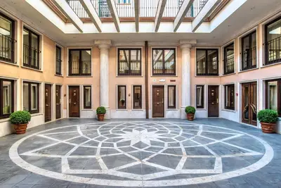 an empty lobby with a large room with a ceiling at River Palace Hotel in Rome