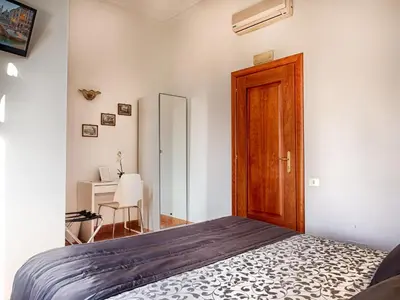 a bedroom with a bed and a wooden door at Sunny Guest House in Rome