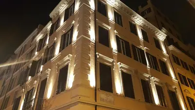 a building with lights on the side of it at Hotel Barocco in Rome