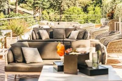 a group of couches sitting on a patio at Garner Hotel Rome Aurelia by IHG in Rome