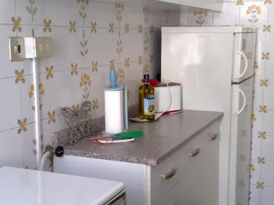 a kitchen with a counter with a white refrigerator at Amici di Roma in Rome