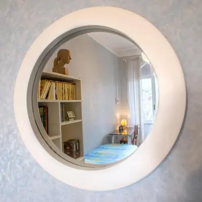 a white mirror in a room with a book shelf at Amici di Roma in Rome