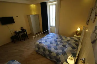 a bedroom with a bed and a table and a window at B&B Rome With Love in Rome