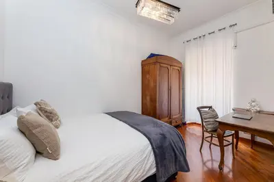 a bedroom with a bed and a table and a desk at S. Cosimato Trastevere in Rome